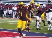  ?? RICK SCUTERI – THE ASSOCIATED PRESS ?? DeaMonte Trayanum scores one of Arizona State’s seven rushing touchdowns against rival Arizona on Friday.