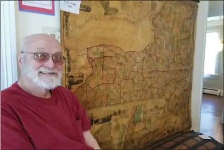  ?? PAUL POST -MEDIANEWS GROUP ?? Stan Malecki admires one of eight large antique wall maps now on display at Parks-Bentley Place, the home of The Historical Society of Moreau and South Glens Falls. The site is open from 1-4 p.m. Saturdays.