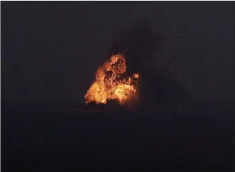  ?? JOHN RAOUX — THE ASSOCIATED PRESS ?? A Falcon 9SpaceX rocket explodes as it crashes in the Atlantic Ocean off the coast of the Kennedy Space Center in Cape Canaveral, Fla., during a test flight to demonstrat­e the capsule’s emergency escape system Sunday.