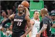  ?? MICHAEL DWYER / ASSOCIATED PRESS ?? Miami Heat’s Bam Adebayo (13) celebrates after scoring against the Boston Celtics during the second half of Game 3 of the Eastern Conference finals Saturday in Boston.