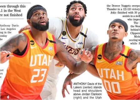  ?? GARRETT ELLWOOD /AGENCE FRANCE-PRESSE ?? ANTHONY Davis of the Lakers (center) stands head and shoulders above Jordan Clarkson (right) and the Utah Jazz.