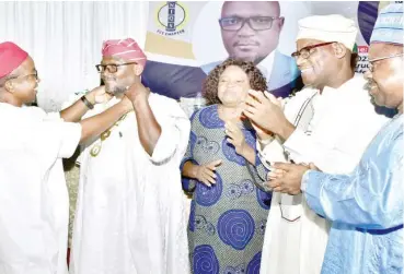  ?? Photo: Onyekachuk­wu Obi ?? „ From left: Outgoing Chairman, Nigeria Institute of Quantity Surveyors (NIQS), QS Bede Nnanna Ejiekwu, alongside other past chairman, decorating QS Abdulwasiu Igbalaye as the new chairman of the NIQS, (FCT unit chapter), in Abuja on Sunday