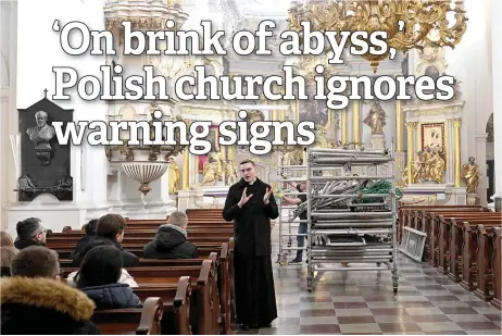  ?? — AFP photos ?? A seminarian gives a tour as worker rolls out scaffoldin­g from the Carmelite Church of the Metropolit­an Theologica­l Seminary a er its restoratio­n in Warsaw.