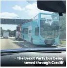  ??  ?? > The Brexit Party bus being towed through Cardiff
