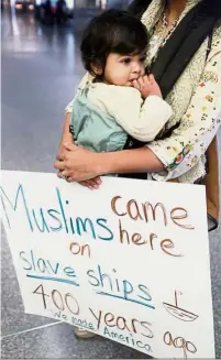 ??  ?? Not on my watch: Amal Khan holding her oneyear-old daughter Razan Sofia Bashir at San Francisco Internatio­nal Airport as she protests Trump’s executive order. — AP
