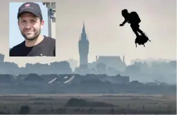  ??  ?? Franky Zapata on his jet-powered “flyboard” flies past the belfry of the city hall of Calais (C) after he took off from Sangatte, northern France, on Sunday. — AFP