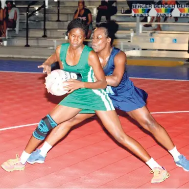  ?? PHOTO BY COLLIN REID ?? Nicole Dixon (in front) of Manchester Spurs seen here in action against Antionette Stone of St Catherine Racers during a recent Berger Elite League game at the Leila Robinson Courts.