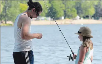  ?? JASON BAIN EXAMINER ?? Mike Baird fishes with Anaiah Baird, 6, in Little Lake near Ashburnham Lock 20 on the Trent-Severn Waterway on July 9. Fishing columnist Rick Daniels offers his dos and don’ts of fishing.