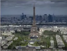  ?? AP photo ?? Stands are under constructi­on on the Champ-deMars with the Eiffel Tower on Monday in Paris.