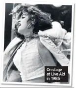  ??  ?? On stage at Live Aid in 1985