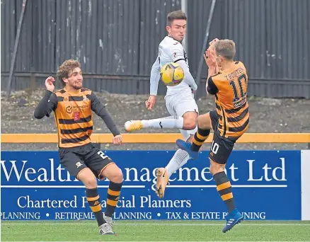  ??  ?? Dunfermlin­e’s Kevin O’hara wins a ball from Alloa’s Alan Trouten watched by Innes Murray of Alloa