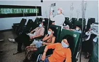  ??  ?? “Combating SARS,” taken in January 2003, captures the scene in a local clinic during the epidemic. — Wang Rongtao
“Field Meeting,” taken in July 1981, shows members of the Yutang Production Group inspecting the harvest, which hit a record
that year. — Gu Fugen