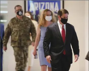  ?? MICHAEL CHOW/THE ARIZONA REPUBLIC VIA AP, POOL ?? ARIZONA GOV. DOUG DUCEY (RIGHT) arrives to give an update on COVID-19 in Arizona during a news conference Wednesday in Phoenix.