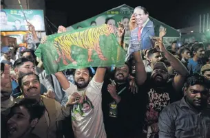  ?? AFP ?? Supporters of former Pakistani prime minister Nawaz Sharif party celebrate in Lahore on Sunday as his wife looked on course to win a parliament­ary by-election.