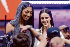  ?? Adam Hunger/associated Press ?? LSU’S Angel Reese, left, and Iowa’s Caitlin Clark, right, pose for a photo before the WNBA draft on Monday in New York.