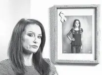  ?? Steve Gonzales / Staff photograph­er ?? Marentha Sargent stands next to a photo of her daughter, Adrienne, who died in 2017 when the child of a family friend discharged a firearm on a kitchen table in Seabrook.