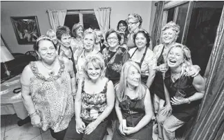  ?? PHOTOS BY MICHEL DUARTE/THE REPUBLIC ?? Fellowship of the bling: Members of the group Wild Boomer Women, most wearing their sparkly tiaras, have a good time when they get together.