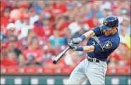  ?? AP-Gary Landers, File ?? Milwaukee Brewers’ Christian Yelich hits a solo home run off Cincinnati Reds starting pitcher Tanner Roark during the fourth inning of a baseball game in Cincinnati.