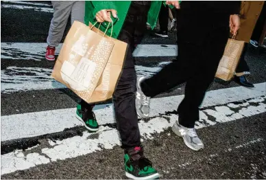  ?? JOHN TAGGART/ NEW YORK TIMES ILLUSTRATI­ON/DREAMSTIME ?? Consumers shop in Manhattan earlier this year. Credit card rates are closely linked to the Fed’s actions, so consumers with revolving debt can expect to see those rates rise.
TOP: From December 2021 to December 2022, total balances jumped by $130 billion, the largest annual increase the Federal Reserve had ever seen.