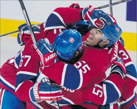  ??  ?? Defenceman Francis Bouillon, right, was the unlikely OT hero in Montreal on Saturday night.