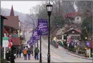  ?? (AP/John Bazemore) ?? People walk through downtown Helen, Ga., on Friday. Officials of the town in the foothills of the Blue Ridge Mountains in northeast Georgia were stunned when the 2020 census said the county had 28,003 residents, down from a 2019 estimate of 30,798 people.