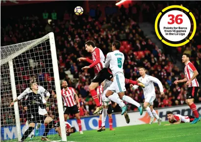  ?? AP ?? Points for Barca from 14 games in the La Liga Athletic Bilbao’s Xabier Etxeita (centre) jumps for the ball beside Real Madrid’s Raphael Varane during the Spanish La Liga match. —