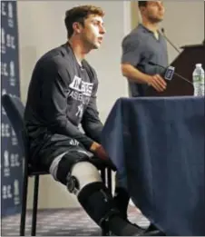  ?? THE ASSOCIATED PRESS ?? Yankees outfielder Dustin Fowler, left, speaks to the media on Wednesday. Fowler ruptured his right patellar tendon last Thursday after crashing into the outfield wall in the first inning of his major league debut in Chicago.