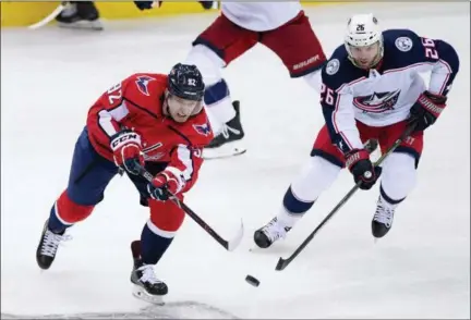  ?? ASSOCIATED PRESS ?? Washington Capitals center Evgeny Kuznetsov (92), of Russia, passes the puck against Columbus Blue Jackets left wing Thomas Vanek (26), of Austria, during the third period in Game 1of an NHL first-round hockey playoff series Thursday in Washington. The...