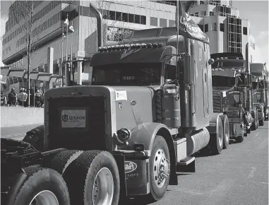  ?? DARRYL DYCK/ THE CANADIAN PRESS FILES ?? Striking truckers park their rigs downtown during a rally in Vancouver in March. The truckers are threatenin­g to once again withdraw their services if they don’t see the pay rate hikes that were promised to end the last labour dispute.