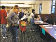  ?? Mary E. O'Leary / Hearst Connecticu­t Media file photo ?? New Haven residents registerin­g to work the polls on Election Day.