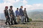  ??  ?? Defence minister Arun Jaitley with troops as he reviews security situation in the Valley in Srinagar on Friday.