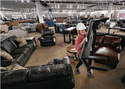  ?? Dan Powers / Associated Press ?? Furniture shopping may be necessary if you moved into a bigger space or got rid of unwanted goods in that process.
