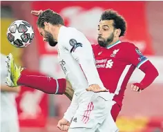  ??  ?? Real’s Nacho denies Liverpool’s Mohamed Salah.