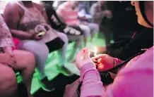  ?? RICHARD VOGEL/AP ?? A tourist lights up a cannabis cigarette during a bus tour in Hollywood. West Hollywood is planning to open pot lounges.