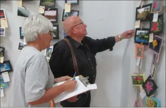  ??  ?? Above: Bill Plomp and Pat Moltzahn judge photo entries at the bench show. Below: Many attended and enjoyed the Aug. 11 pancake breakfast.