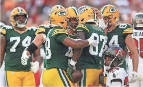  ?? NATHAN RAY SEEBECK/USA TODAY SPORTS ?? Packers wide receiver Romeo Doubs is congratula­ted by quarterbac­k Aaron Rodgers after scoring a TD against the Bucs.