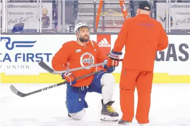  ?? ROSS D. FRANKLIN/ASSOCIATED PRESS ?? Washington coach Barry Trotz talks to his kneeling superstar, Alex Ovechkin, during a Wednesday practice session in Las Vegas. The Capitals play the Golden Knights tonight in Game 5.
