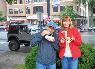  ?? NICHOLAS BUONANNO — NBUONANNO@TROYRECORD.COM ?? Bob Allen and Cathy Allen enjoy some food during the fourth annual Saratoga Internatio­nal Flavorfeas­t in downtown Saratoga Springs on Saturday.