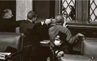  ?? J. Scott Applewhite / Associated Press ?? Police draw their guns as protesters try to break into the House chamber at the U.S. Capitol on Wednesday. A full rebuke of President Donald Trump and this behavior requires impeachmen­t.