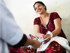  ??  ?? Nepali mother Pabitra Dhungel receiving cash for transporta­tion at a health centre in the Ramechhap district, some 100km east of Kathmandu, so that she is able to access medical services.