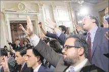  ?? MARIO TAMA / GETTY IMAGES ?? Reporters try to pose questions earlier this month to President Donald Trump during a news conference to announce his new nominee for Labor secretary.