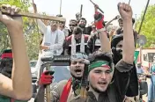  ?? AAMIR QURESHI TNS ?? Supporters of Pakistan’s former prime minister, Imran Khan, march toward Khan’s residence in Lahore on Thursday. Legions of Khan’s angry supporters fought off riot police attempting to arrest the former cricket star.