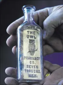  ??  ?? This drugstore bottle, from around 1909-1910, is from the Owl Pharmacy in the long-extinct mining town of Seven Troughs in Pershing County.