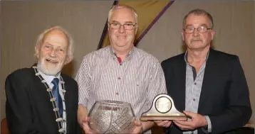  ??  ?? John White of D.M.P. (centre), winner of the lifetime service to athletics award, with Nicky Cowman (President) and Paddy Morgan (Chairman).