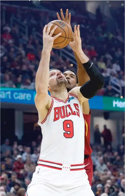  ?? RON SCHWANE/AP ?? Bulls center Nikola Vucevic shoots inside against Cavaliers big man Evan Mobley during the first half Saturday.