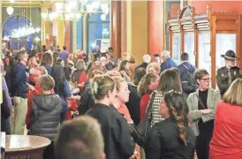  ?? MICHELLE GUTIERREZ/THE REGISTER ?? Supporters of Iowa’s Area Education Agencies wait in the hallway Feb. 21 after a public hearing at the Iowa Capitol on the House version of a bill to overhaul the program.