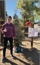  ?? Courtesy photo ?? Ben Gersh placed a tree and sign in front of his home before Christmas, with free candy canes and gifts. The wrapped presents came from Gersh and his mother, Danielle, as well as from others in the community for anyone in need.