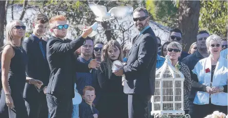  ?? Picture: ADAM ARMSTRONG ?? Sara Zelenak’s mother Julie Wallace (left), brothers Scott and Harrison and her stepfather Mark Wallace release a white dove at her funeral at Moreton Bay College.