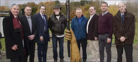  ??  ?? Peter Houlihan, Lar Behan, Minister Harris, Joey Burns, Tommy Murphy, Aidan Gregan, Darragh Gregan and Joe Dolan by the new sculpture.