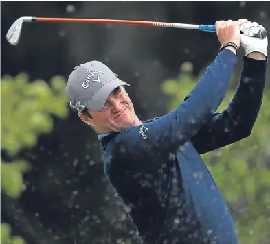  ??  ?? Marc Warren hits his tee shot on the seventh. A 67 left him four shots off the lead. Picture: Getty.